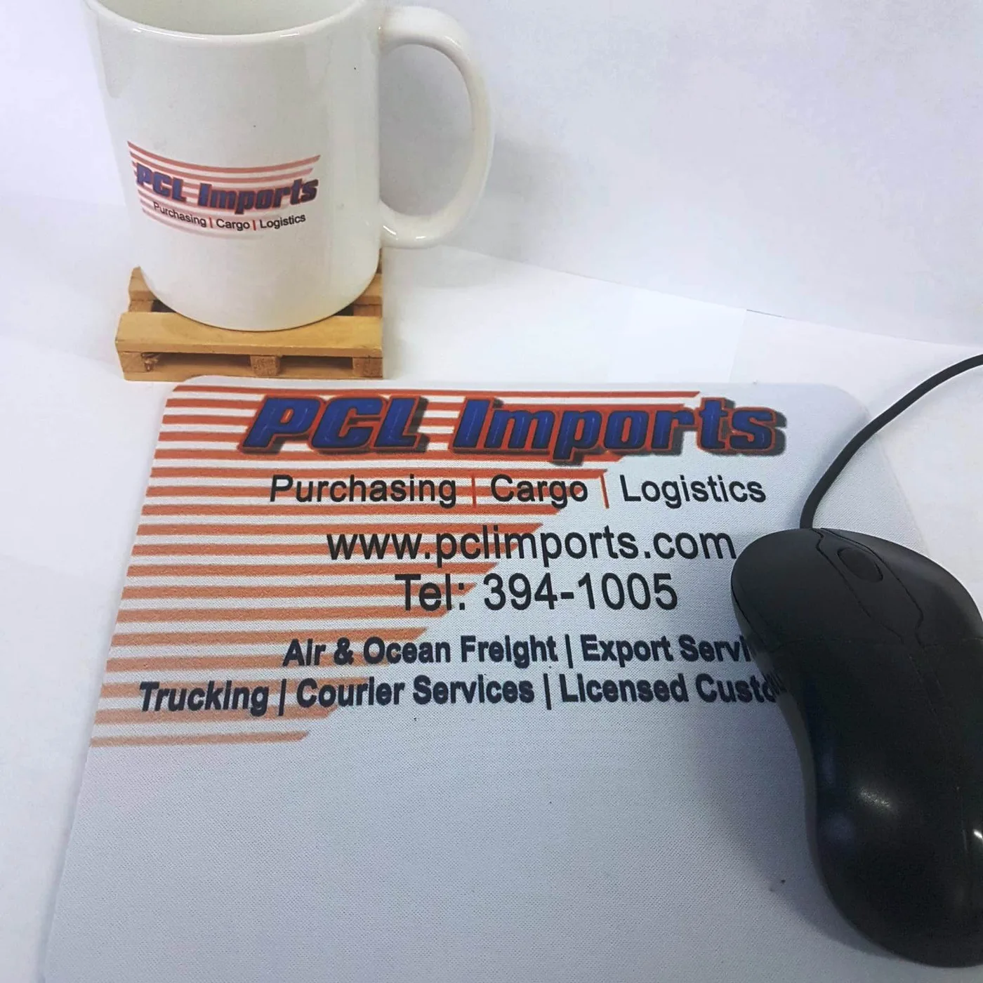 Original PCL Imports branded mug and mouse pad, with the PCL logo and shipping services