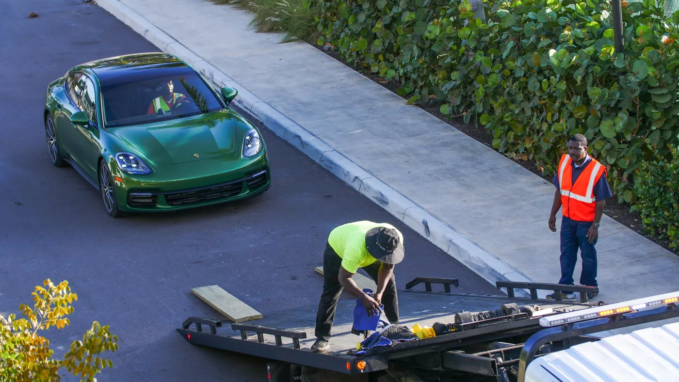 The PCL team loading a green Porsche onto a flatbed in The Bahamas